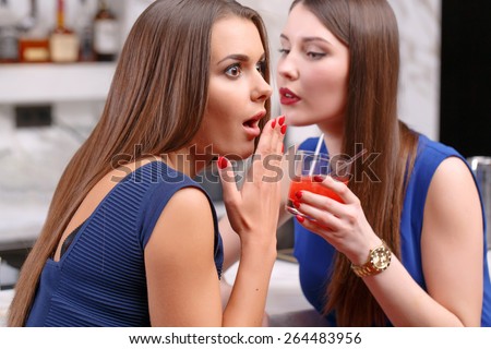 Cannot believe it. Close-up of a beautiful girl looking shocked and puzzled when her friend tells something to her