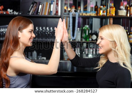 Great job. Two beautiful smiling girls clapping their hands delighted and cheerful