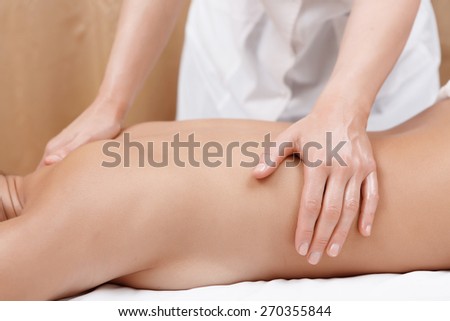 No pain just pleasure. Close-up of female masseur hands giving back massage to a young woman