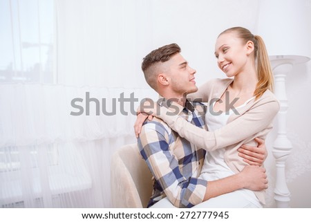 All you need is love. Young lovely couple sitting and hugging each other