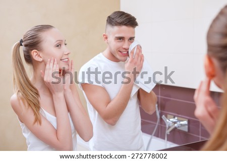 Feel clean. Young couple doing morning routine together in front of mirror in bathroom.