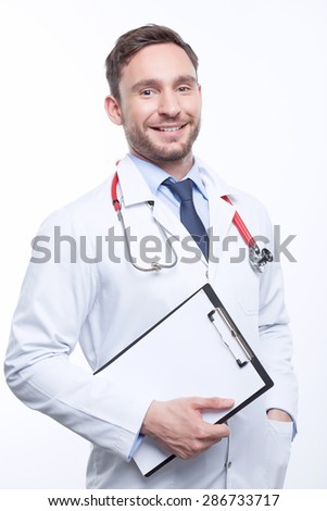 Do you need my help. Nice doctor holding  papers and keeping the hand in hin pocket while standing isolated on white background.