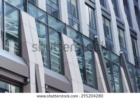 Vision of modernity. Underside angle view of modern glass  high building with steel frames  and well designed balcony.