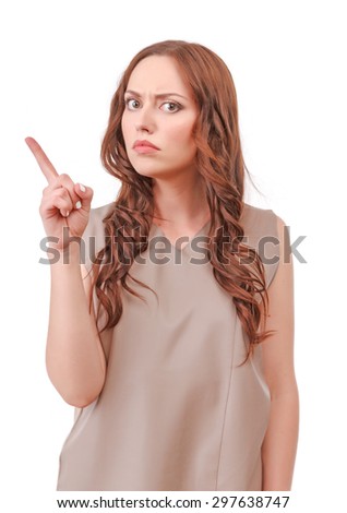 Do not do this. Portrait of strict red-haired woman pointing with her index finger isolated on white background