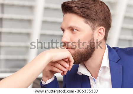 Elegant gesture. Portrait of young-looking handsome man kissing hand of his charming girlfriend