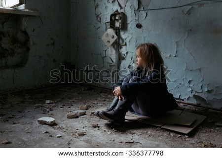 Give me support. Poor depressed little girl folding her legs and sitting on the floor while looking up