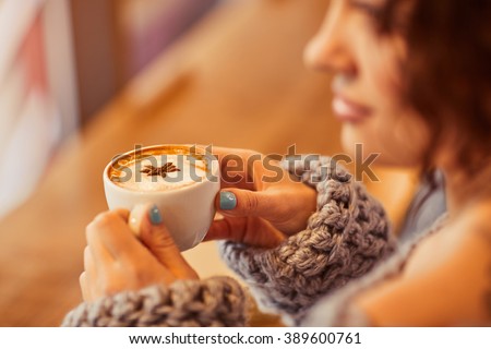 Pleasant woman drinking coffee