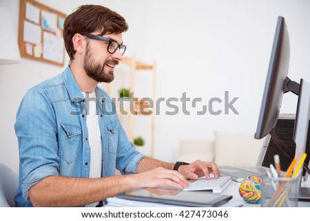 Glad man working on computer