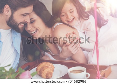 Cheerful vibrant family enjoying happy moments