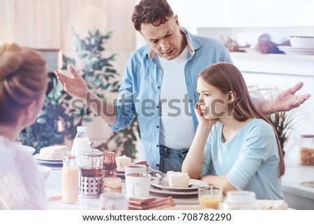 Concerned father getting emotional while yelling his teenage daughter