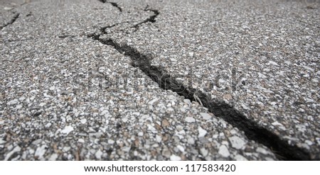 Cracked road on asphalt close up