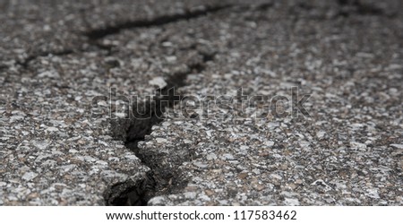 Cracked road on asphalt close up