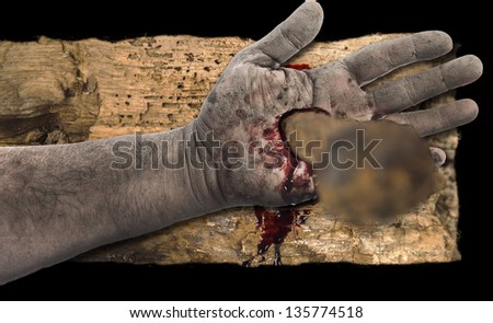 Bleeding hand with nail in it on wood