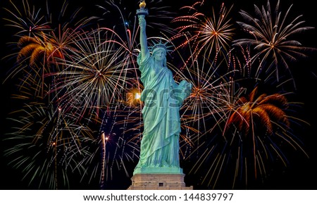 Colorful fireworks on black sky with statue of liberty