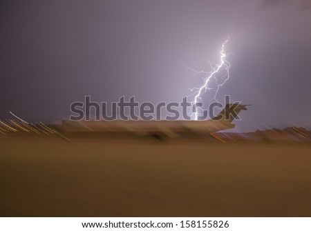 Jet aircraft with motion blur on ground with lightning strike