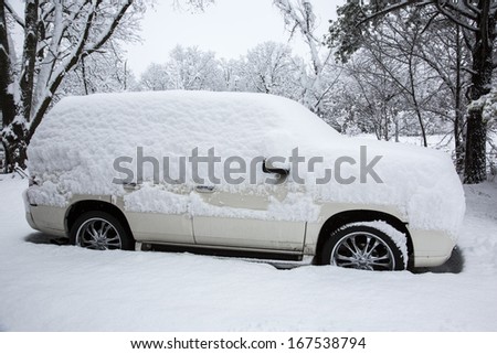 Snow covered cars in street