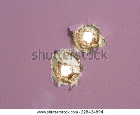 Bullet hole in painted wood