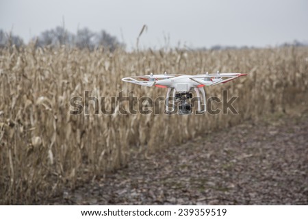 St.Louis Missouri. - DECEMBER19: Editorial photo of a DJI Phantom drone in flight with a mounted GoPro Hero3 Black Edition digital camera on December 19, 2014 in St.Louis Missouri over corn field