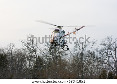 Helicopter landing in field with snow