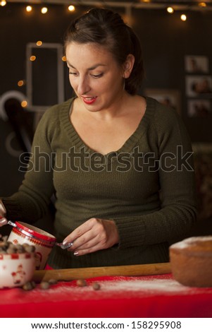 Woman looking inside the Christmas jar disappointed.
