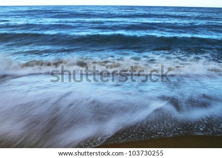 Strong tidal waves during sunset in Pacific Ocean