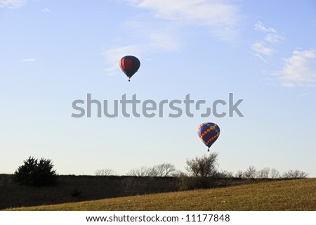 Red hot air balloon over farm fields near Omaha Nebraska