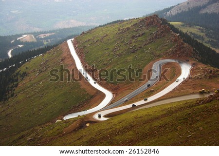 Winding road to Pike?s Peak in Colorado surrounded by colorful mountain prairies during drizzle rain