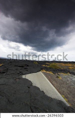 Flow of black lava blocking the road in Hawaii Volcanoes National Park