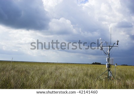 Scientific instrument against the cloudy blue sky background in the field