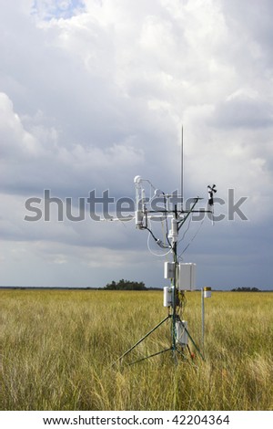 Scientific instrument against the cloudy blue sky background in the field