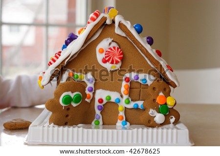Gingerbread cookie house dotted with colorful candy