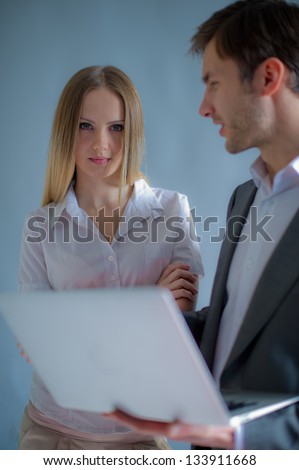 business conversation of partners of the man and the woman of businessmen, at office