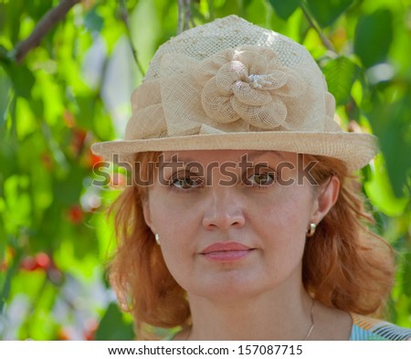 face of a beautiful woman at the age of 50 years in the garden background