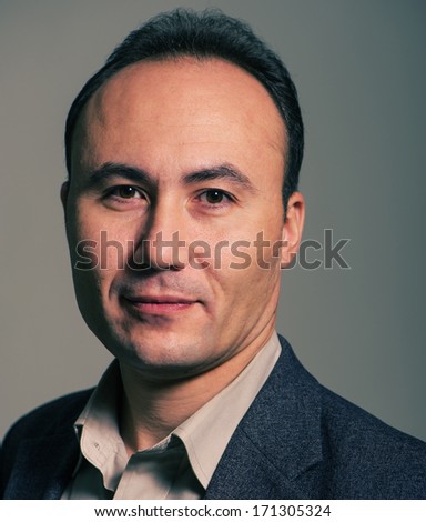 businessman in a suit looking at the camera, close up, age thirty-five, thirty-seven years