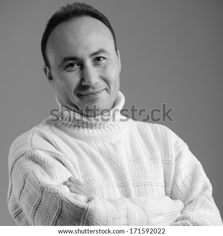 Portrait of a businessman in a sweater and smiling, age thirty-five, thirty-seven years