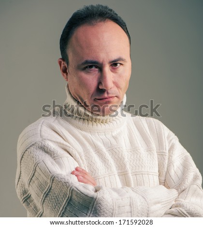 Portrait of a businessman in a sweater looking at the camera in disbelief, age thirty-five, thirty-seven years