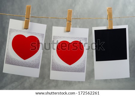 old photos with the image of heart valentine hanging on a rope on clothespins