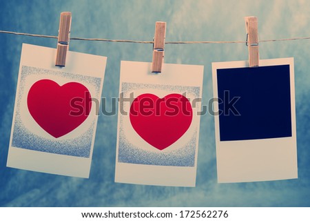 old photos with the image of heart valentine hanging on a rope on clothespins