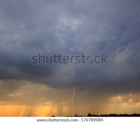 bolt of lightning from the rain clouds at sunset, spring season
