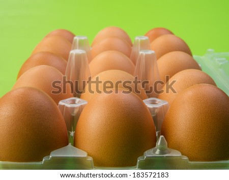 fresh brown chicken eggs in diet package open, closeup