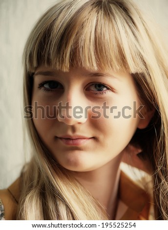 portrait of a young pretty blonde with her hair in the room