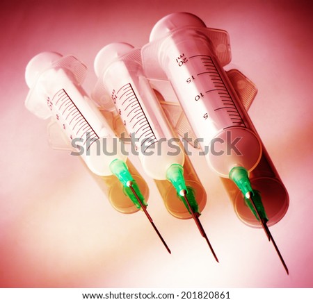 three disposable syringes are isolated on  white background
