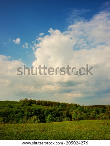 Landscape in a hilly area in the spring cloudy day. Ukraine, Europe. Beauty world.