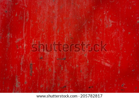 dirty metal surface painted in red color illuminated by sunlight
