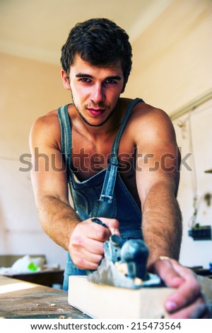 Portrait of a young man working that handles woodwork tool