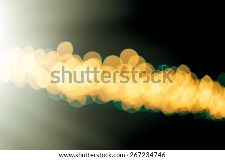 blurred spots and golden light on a dark background
