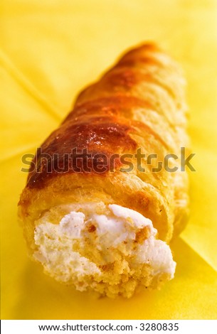 cake lays on  napkin of yellow color,  close up
