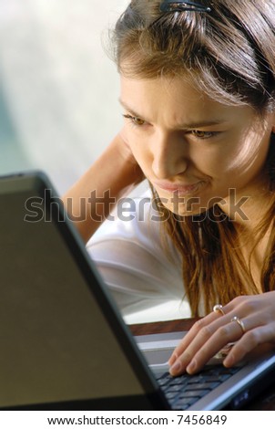young nice girl the student works with laptop
