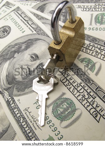 closed padlock with keys on  background dollar banknotes,  close up