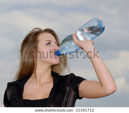 nice young beautiful woman drinks water and  plastic bottle